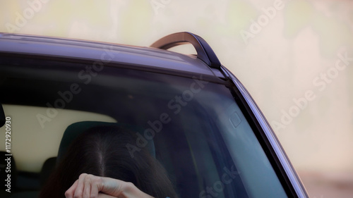 Obraz na płótnie Tired young woman holding her head while driving car w salonie