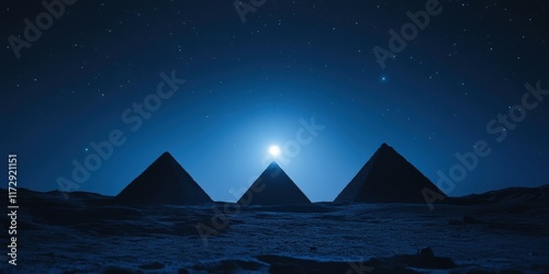 Majestic pyramids illuminated by moonlight under a starry sky in Giza, Egypt at night