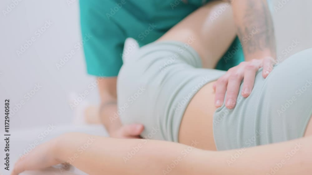 Physical Therapist Assisting With Treatment On Patient's Back