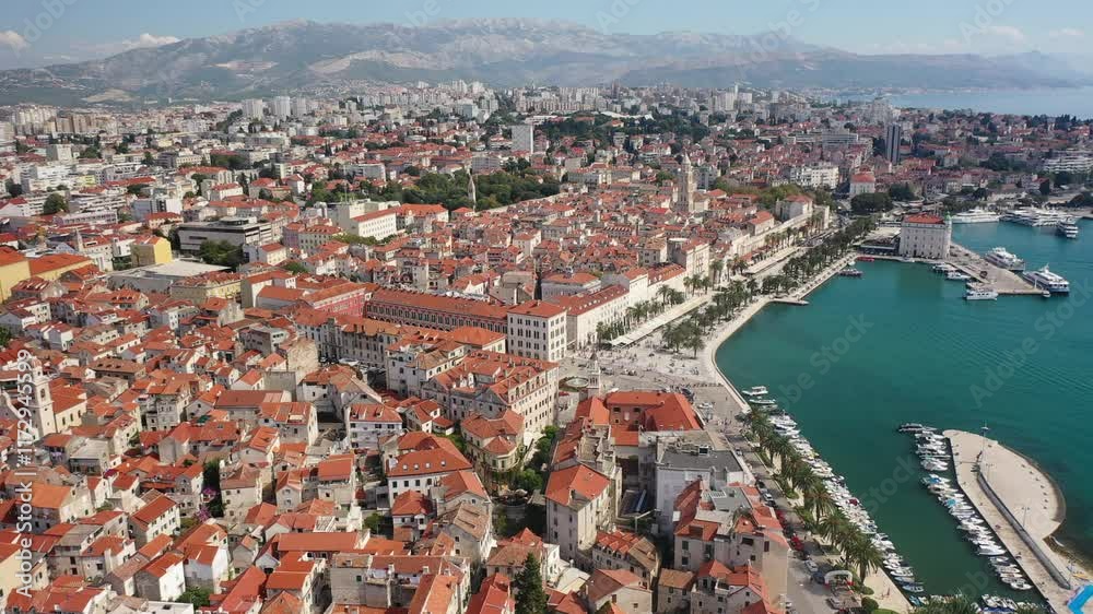 A magnificent drone view showcasing the entirety of Diocletian's Palace and the city of Split. The bright sun highlights the ancient Roman architecture and the stunning Adriatic coastline. A magnificent drone view showcasing the entirety of Diocletian's Palace and the city of Split. The bright sun highlights the ancient Roman architecture and the stunning Adriatic coastline.