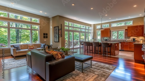 A stylish open living space with a fully equipped modern kitchen  island seating  and floor-to-ceiling windows inviting in ample natural light.