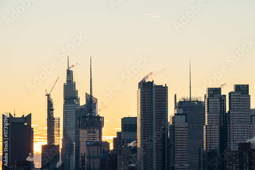 NYC skyscrapers in silhouette stunning morning light, city scape water reflection, background image, world famous destination photo