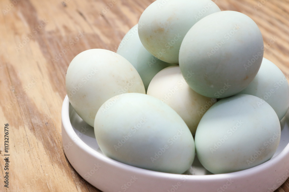 A Delightful Collection of Pastel-Colored Eggs Nestled in a White Bowl