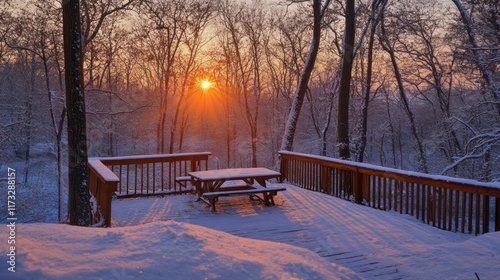 Snow-covered deck at sunset in a serene winter forest.