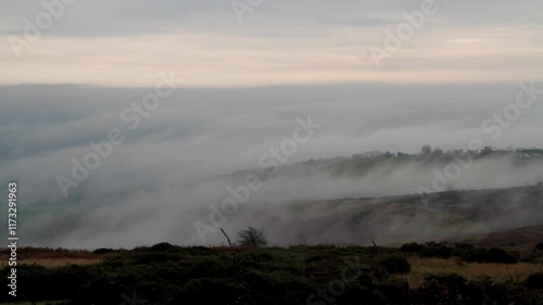Clee Hill geen moor near Ludlow, Shropshire, looking across at a temperature inversion, low clouds or water vapour, wide angle, landscape. Zoom in during the clip.
