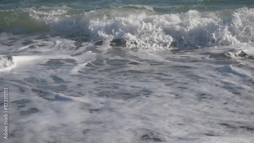 Gentle Waves are Lapping on a Beautifully Serene Shore, Creating a Peaceful Atmosphere