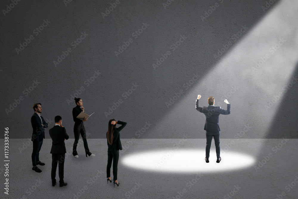 Fototapeta premium Businessperson under spotlight with others observing in dark grey background. Concept of career choice, ambition, and success.