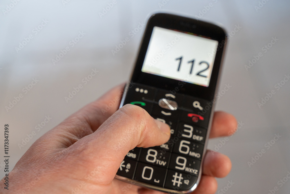 Dialing 112 emergency services, calling on a mobile cell phone Dialing 112 emergency services, calling on a mobile cell phone