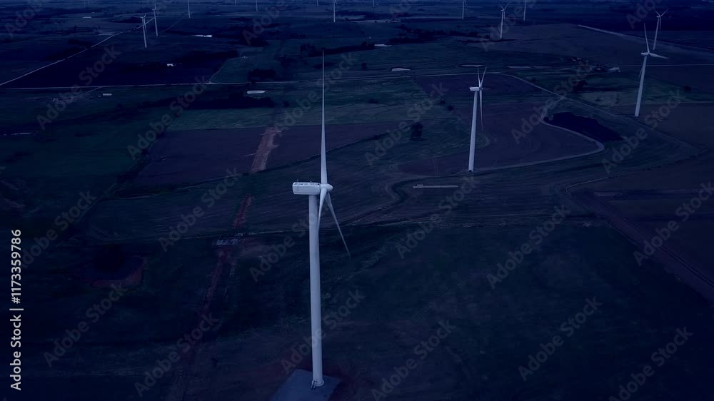Aerial view of wind turbines at night, slider action drone footage.