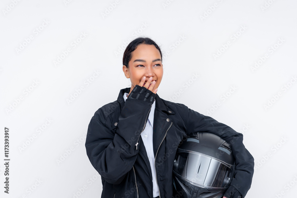 A young female motorcycle delivery driver giggling while holding her helmet. Isolated on a white background. A young female motorcycle delivery driver giggling while holding her helmet. Isolated on a white background.