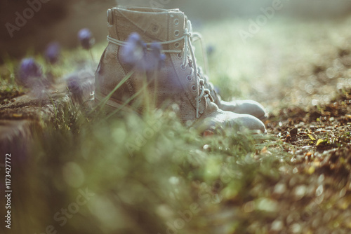 Close-up Side view of a pair of boots in a garden by a wall photo