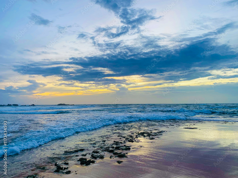 Fototapeta premium Beautiful Hikkaduwa Beach Embraced by Sunset’s Glow in Sri Lanka