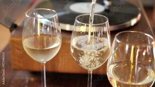 bubbles of French champagne or prosecco in a glass, Pour white wine, champagne or prosecco into a glass from a bottle for an aperitif at home