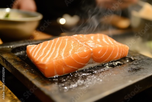 Raw Salmon Fillet Sizzling on Hot Stone Grill