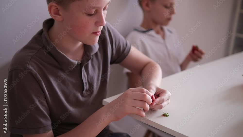 Boy eating berries. Summer healthy food. Vitamins
