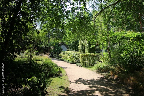 hiking trail in a pretty school garden with decorative green hedges