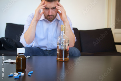Depressed man taking some pills