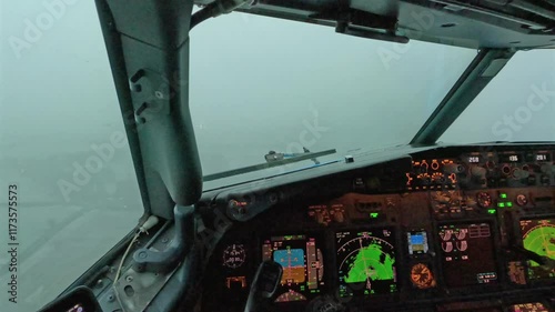 Captain pilot cockpit view landing aircraft in storm, rain, bad weather conditions on runway