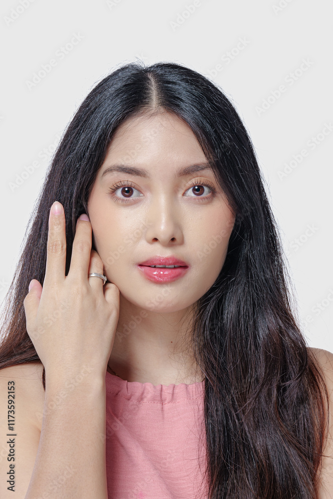 Elegant young Asian woman with beautiful make up doing a chic pose isolated by white background. Elegant young Asian woman with beautiful make up doing a chic pose isolated by white background.