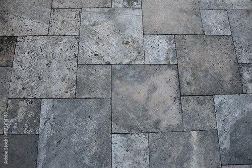 close-up of a Mediterranean terrace floor with different sized square tiles