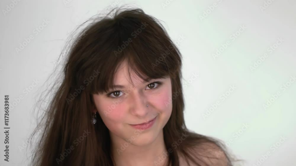 Young Woman in Studio Playfully Engaging with Camera Young Woman in Studio Playfully Engaging with Camera