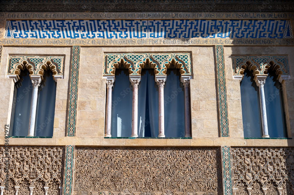 Fototapeta premium Walls of palace in historical Andalusian town Seville, Spain. View on houses, architectural details of buidings. Summer in Andalusia.
