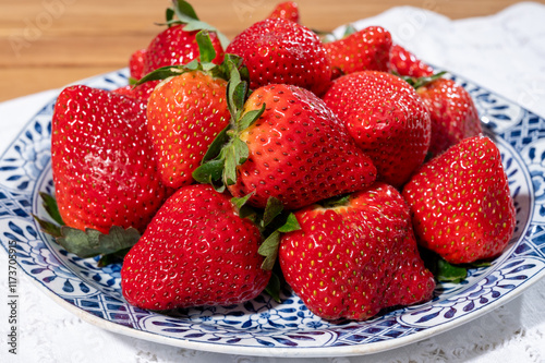 New harvest, plate of ripe red sweet strawberry ready to eat