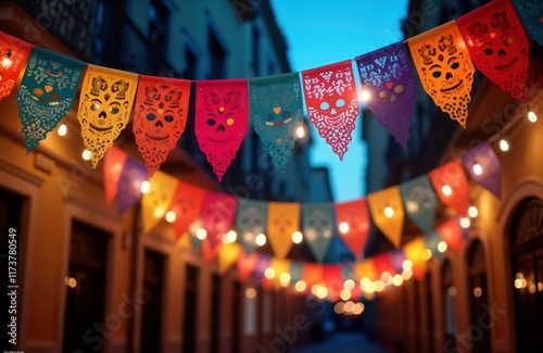 Colorful papel picado decorations hang gracefully from ropes at night party. Vibrant colors, intricate designs of colorful skull motifs decorate festive scene. Event probably part of traditional photo