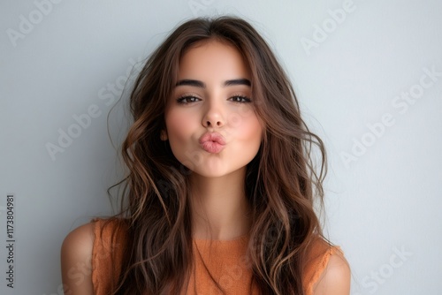Beautiful young woman sending a kiss to the camera