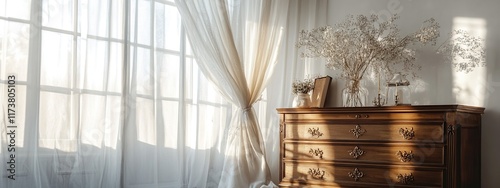 Morning light through the window with a wooden chest of drawers in a luxurious room featuring classic furniture and elegant decoration