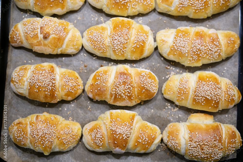 Top view of homemade mini croissants on a sheet pan Top view of homemade mini croissants on a sheet pan