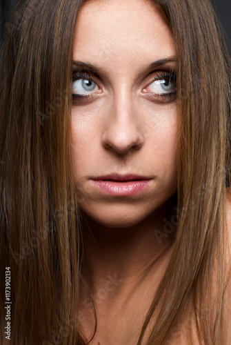 Close-Up Portrait of a Woman With Thoughtful Expression and Long Hair