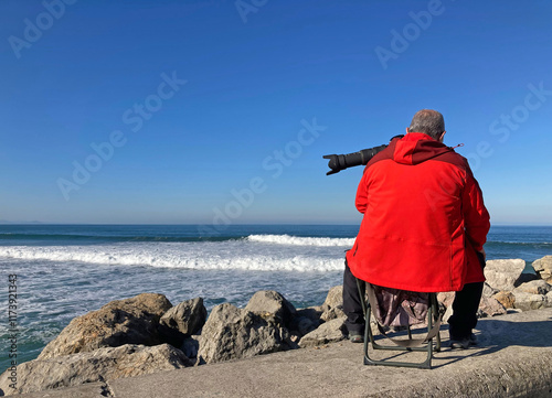 hombre fotógrafo sentado sacando fotografías a   la playa a la orilla del mar donostia san sebastian playa de gros zurriola  IMG_9215-as25 photo