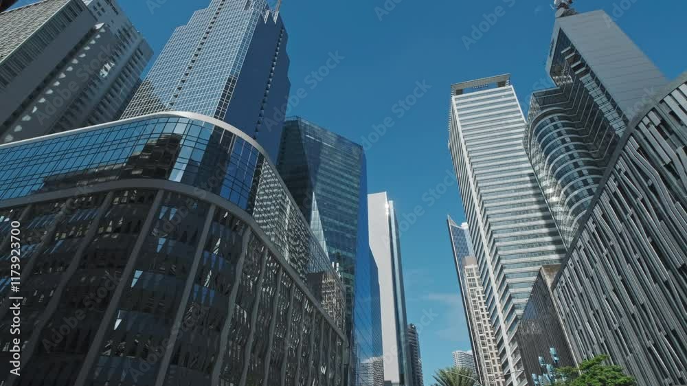 Skyscrapers soar against a bright blue sky in an urban cityscape, Manila, Philippines, 4k Skyscrapers soar against a bright blue sky in an urban cityscape, Manila, Philippines, 4k
