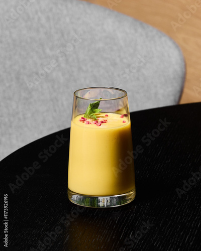 Enjoy a Refreshing Mango Smoothie topped with beautiful, vibrant Edible Flowers for a unique treat photo