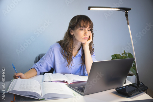 Tired worker working late in front of the laptop 