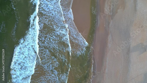 Aerial View of Ocean Waves Crashing on Sandy Beach Relaxing Coastal Scenery