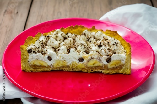 Authentic banoffee cake with banana and caramel sauce filling sprinkled with grated dark chocolate and coffee . English traditional pie photo