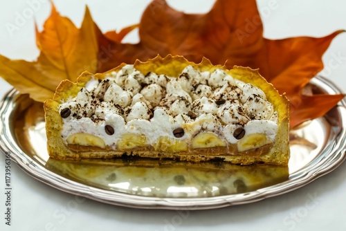 Authentic banoffee cake with banana and caramel sauce filling sprinkled with grated dark chocolate and coffee . English traditional pie photo