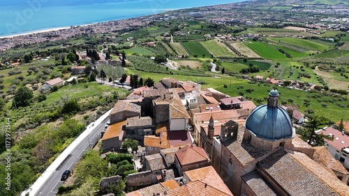 Aerial drone view of Montepagano hill with buildings in the province of Teramo in Italy and the Adriatic Sea.
