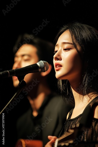 Passionate duet performance under soft lighting, capturing emoti
