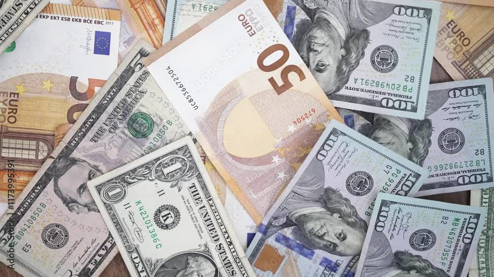 Table cluttered with euro and dollar notes captures essence of forex trading with investors speculate on currency values to profit from fluctuations between currencies Table cluttered with euro and dollar notes captures essence of forex trading with investors speculate on currency values to profit from fluctuations between currencies