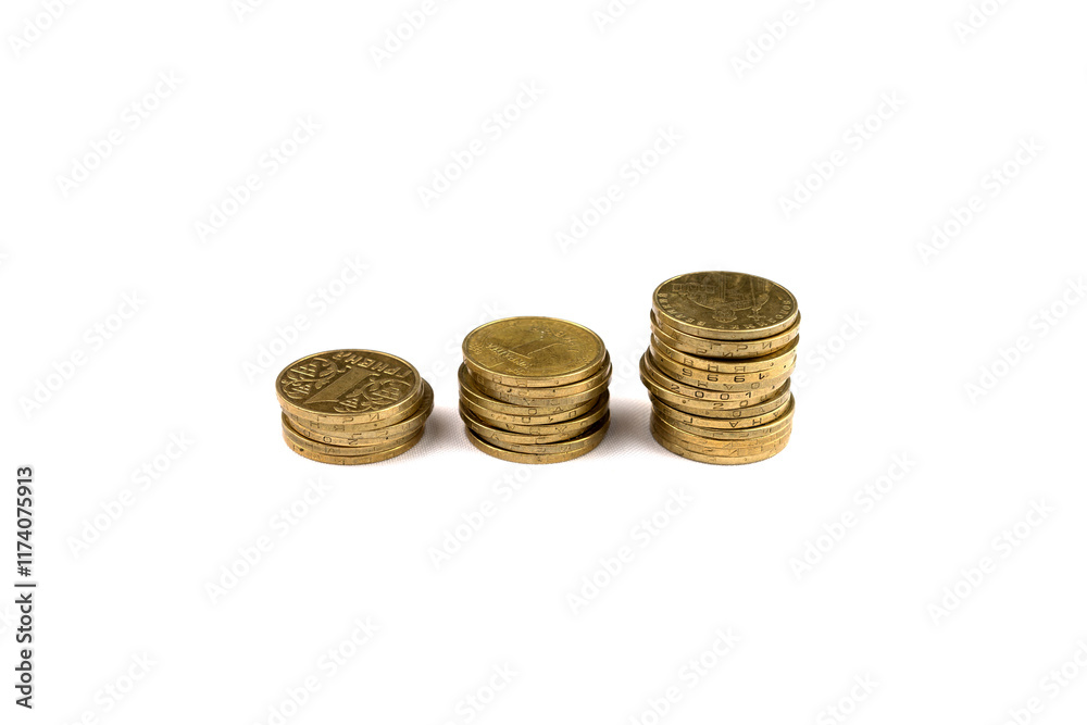 Stacks of coins arranged by size on a clean surface in natural light Stacks of coins arranged by size on a clean surface in natural light