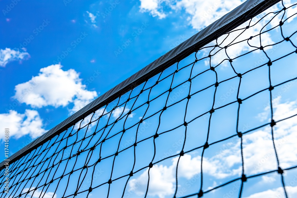 On a bright, sunny day, a tennis or volleyball net stands out against a clear blue sky, viewed from a low angle at an outdoor sports field On a bright, sunny day, a tennis or volleyball net stands out against a clear blue sky, viewed from a low angle at an outdoor sports field
