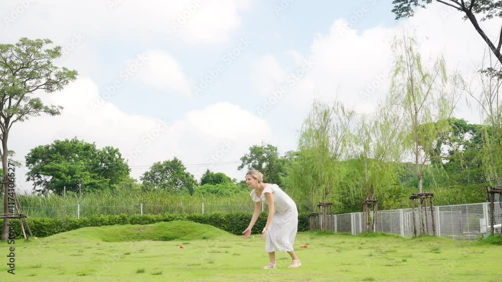Happy woman playing ball with golden retriever breed dog at pets friendly dog park. Domestic dog with human dog moms enjoy outdoor active lifestyle on summer holiday vacation. Pet humanization concept Happy woman playing ball with golden retriever breed dog at pets friendly dog park. Domestic dog with human dog moms enjoy outdoor active lifestyle on summer holiday vacation. Pet humanization concept