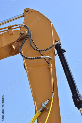 The yellow crane is a manipulator with a hydraulic cylinder.