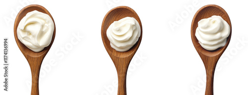 three wooden spoons. each holding a dollop of creamy substance. likely mayonnaise or a similar condiment the spoons are arranged side by side against a plain white background. emphasizing the texture