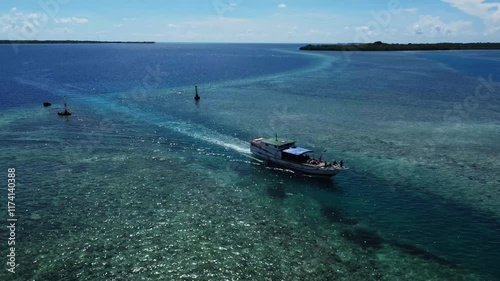 Wooden boat moves slowly toward the harbor.