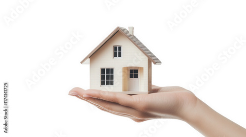 small model house held in a person's hand against a light background. symbolizing home ownership. real estate. or the concept of shelter it conveys a sense of care and protection associated with housi photo