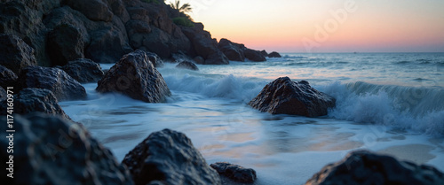 Serene ocean waves lapping against rugged rocks at twilight, conveying tranquility and reflection, with a soft pastel sky blending shades of pink and blue in the background photo